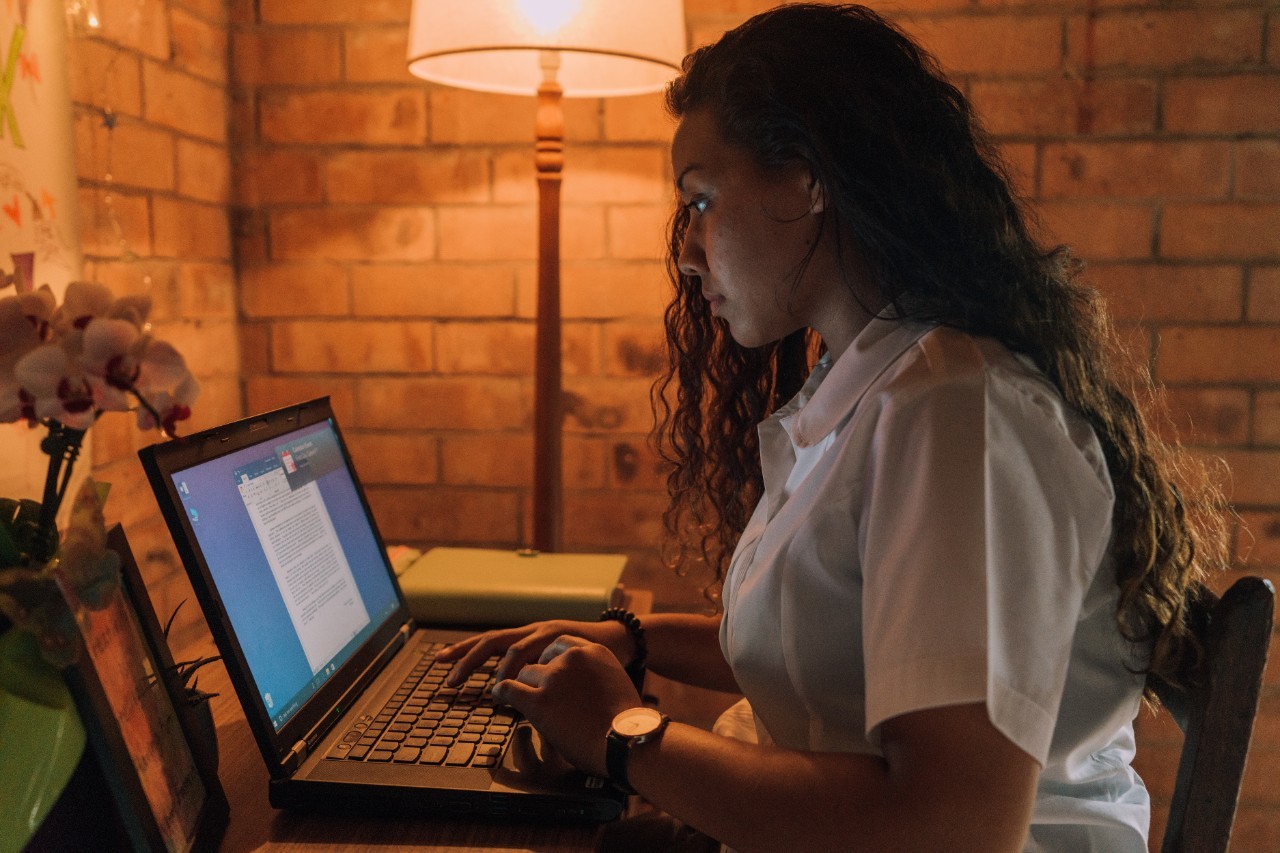 Student studying at home on laptop.